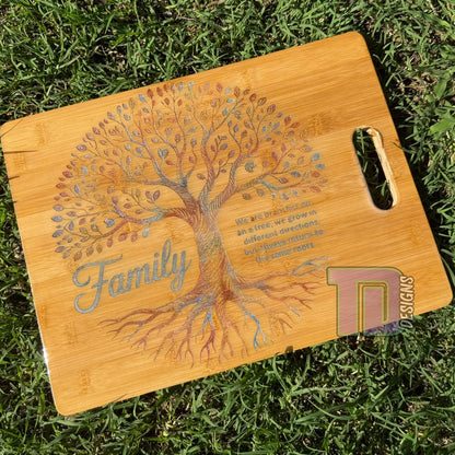 Wooden cutting board with family tree design on grass